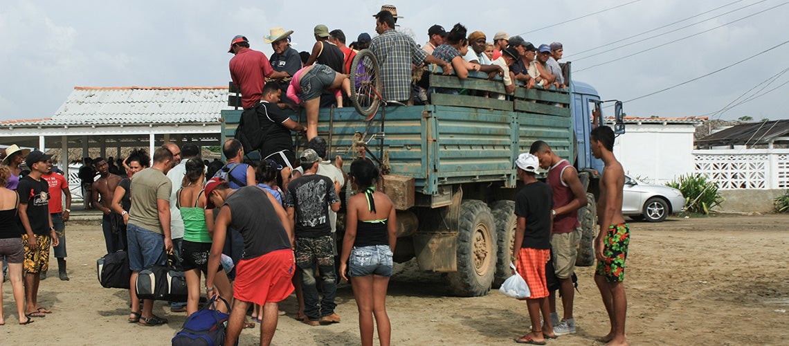 Central American migrants boarding a truck on their way to the United States Central American migrants boarding a truck on their way to the United States